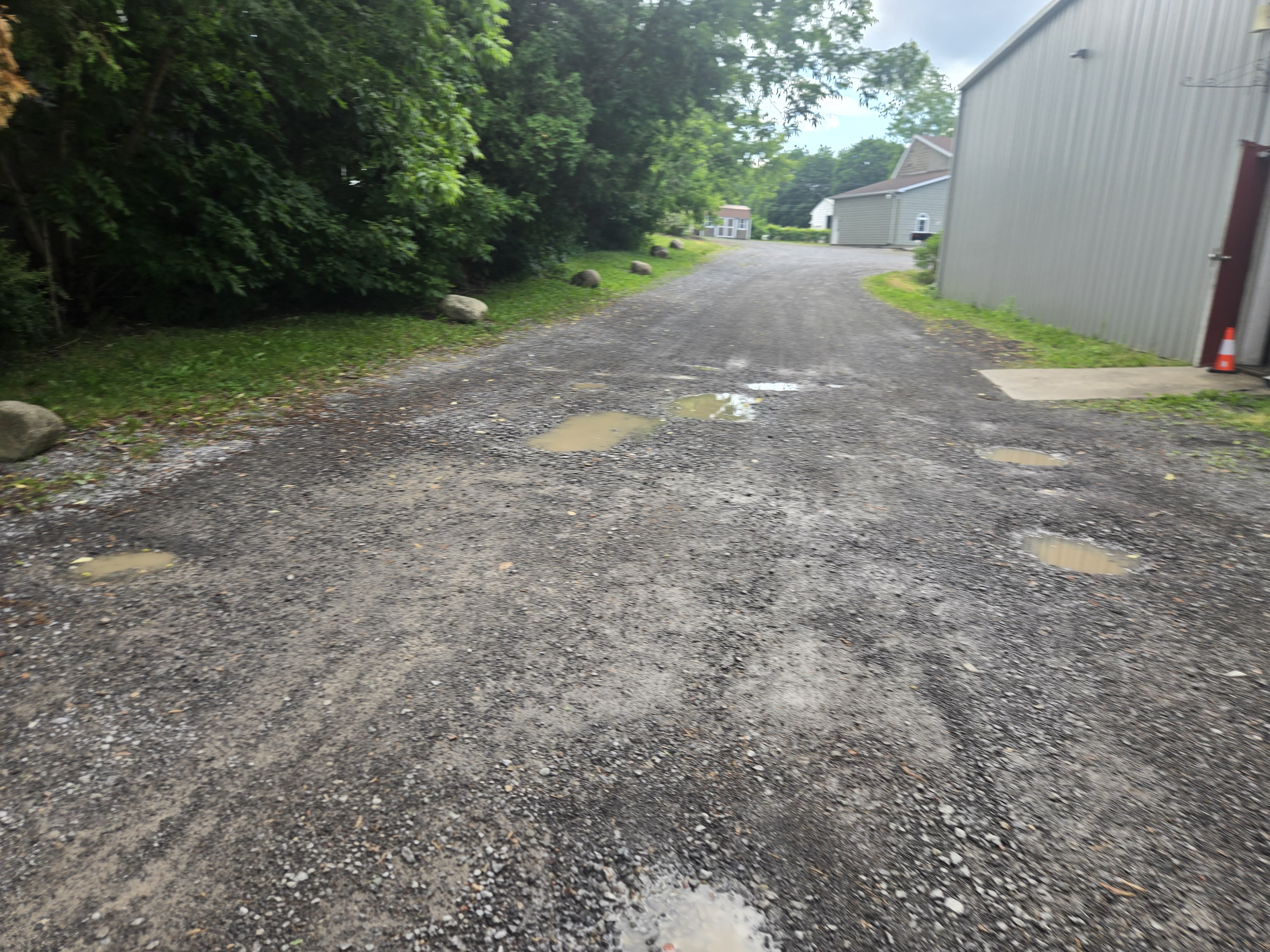 Commercial driveway before repair - potholes and damage