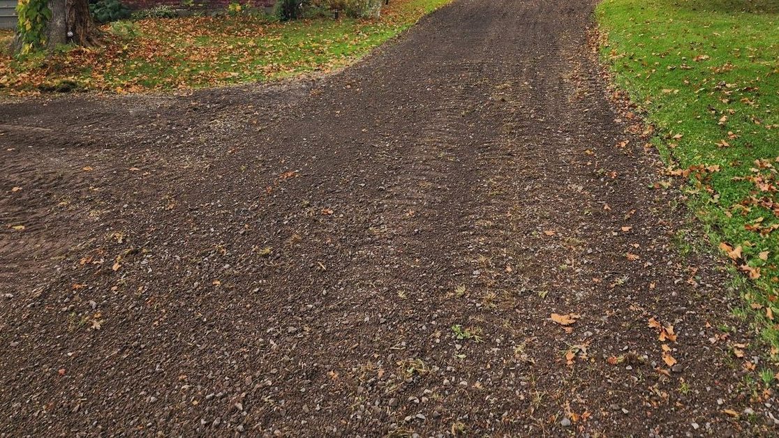 Residential gravel driveway after full repair - smooth and freshly graded