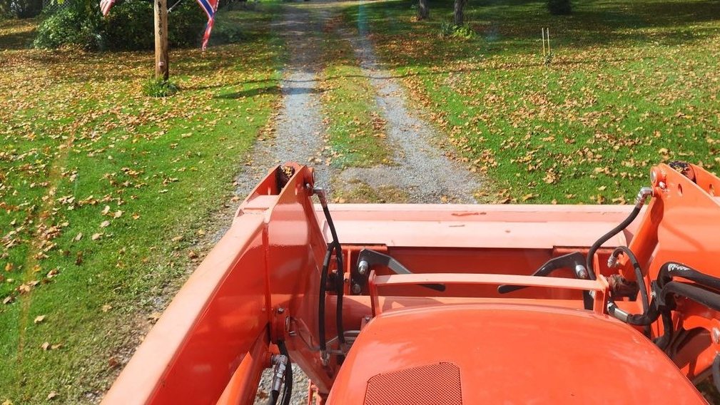 Residential gravel driveway before full repair - washed out and rutted